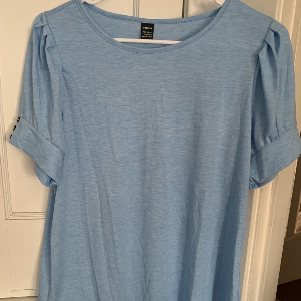Blue top with elbow length banded sleeves. New!!